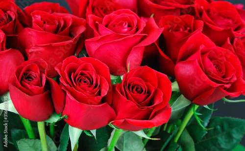 fresh red roses in a bouquet as background