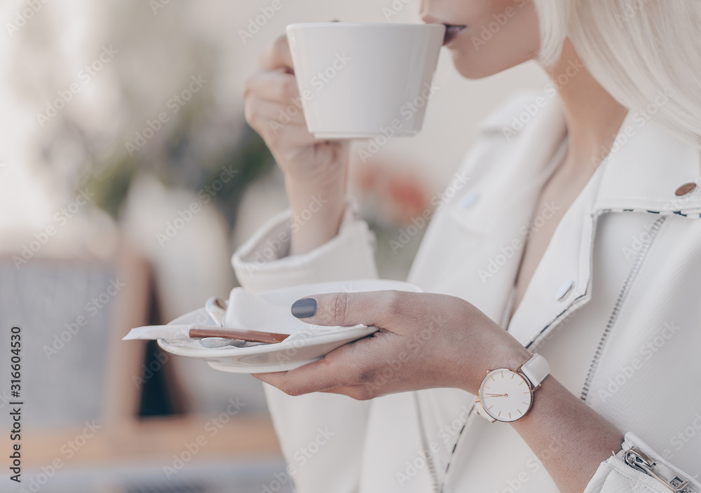 Beautiful white watch on woman hand. Holding coffee cup. Beautiful white watch on woman hand. Holding coffee cup.