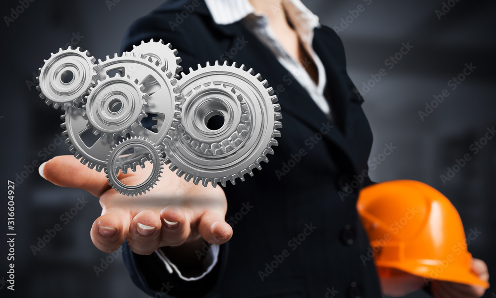 Businesswoman holds in palm gears mechanism Businesswoman holds in palm gears mechanism