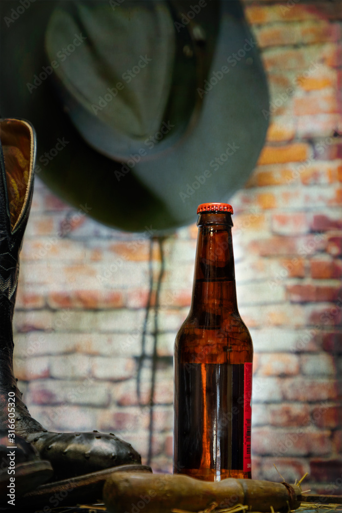 Beer Bottle with Cowboy boots, in background a cowboy hat Stock Photo |  Adobe Stock