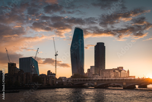 Newly built One Blackfriars residential skyscraper near Thames river by sunset photo