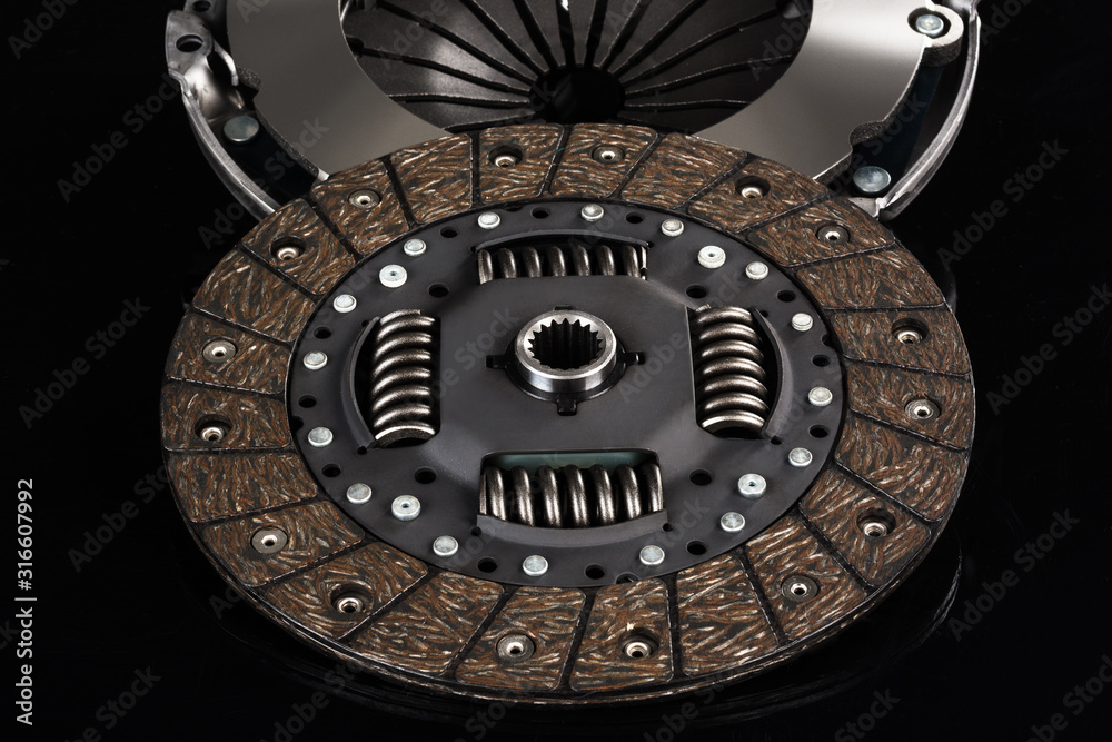 Naklejka premium Car or automotive clutch on black background