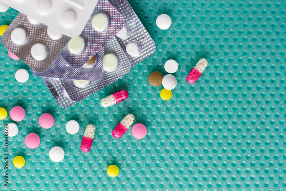 Pills and ampoules with medicine are scattered on the table Pills and ampoules with medicine are scattered on the table