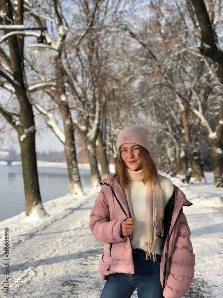 Teenage girl in park, Winter background, River view Teenage girl in park, Winter background, River view