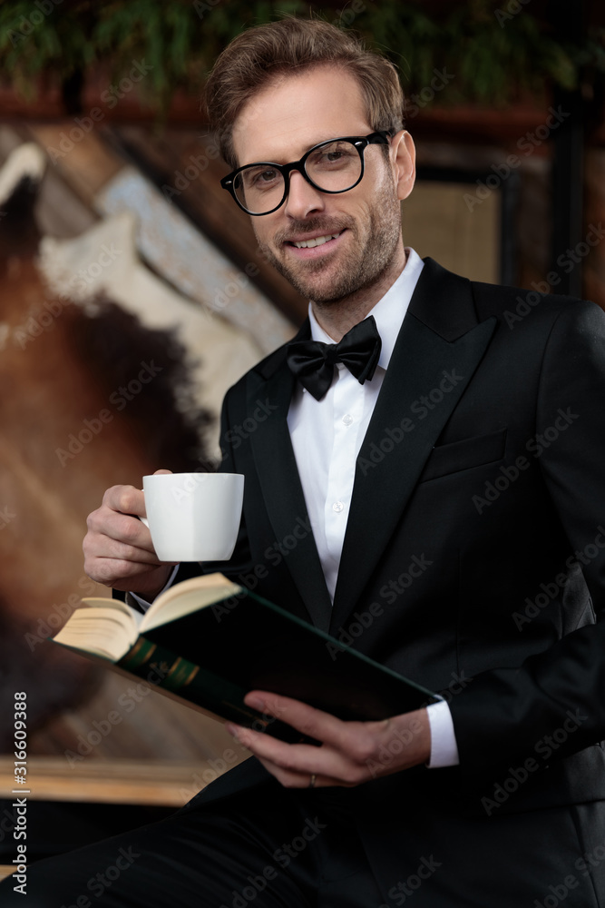 Happy fashion model smiling, holding a coffee cup and book Happy fashion model smiling, holding a coffee cup and book