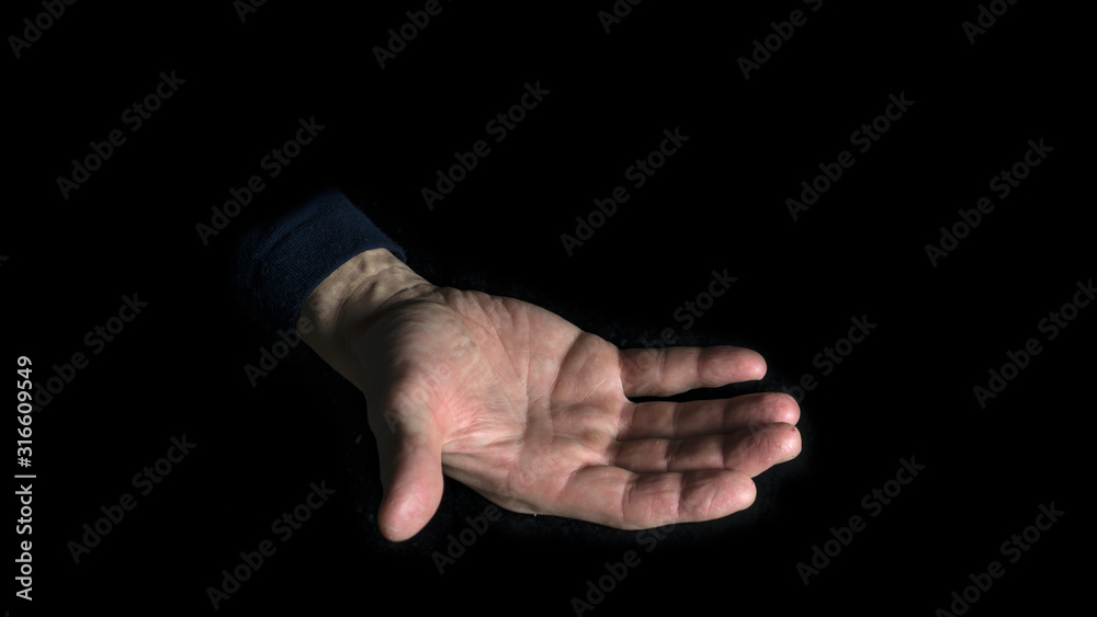 Empty open hand on a black background