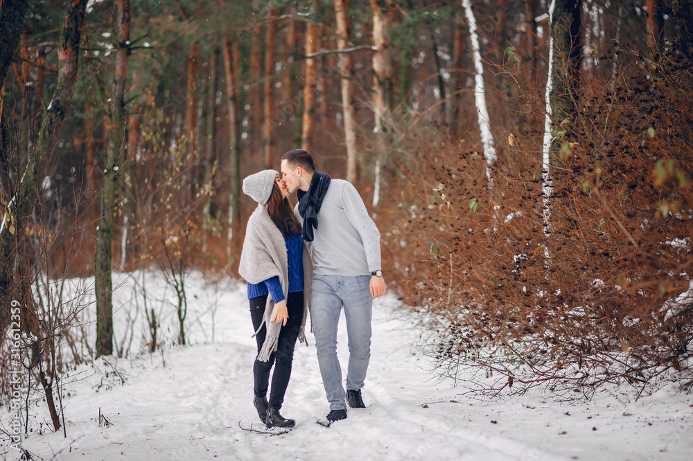 Couple in a winter forest. Beautiful girl in a blue sweater. Couple in a winter forest. Beautiful girl in a blue sweater.