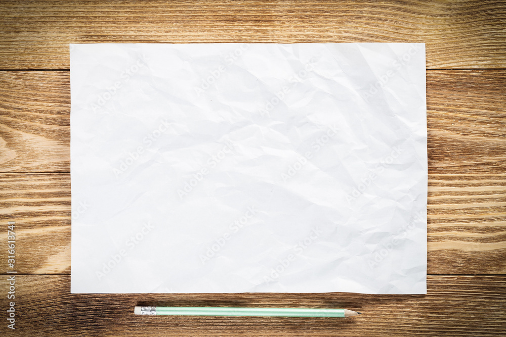 Sheet of paper lying on wooden table