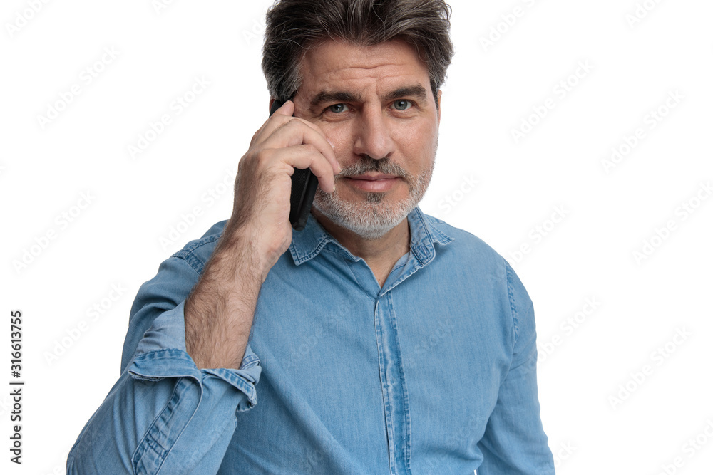 Handsome old casual man talking on his phone and smiling Handsome old casual man talking on his phone and smiling