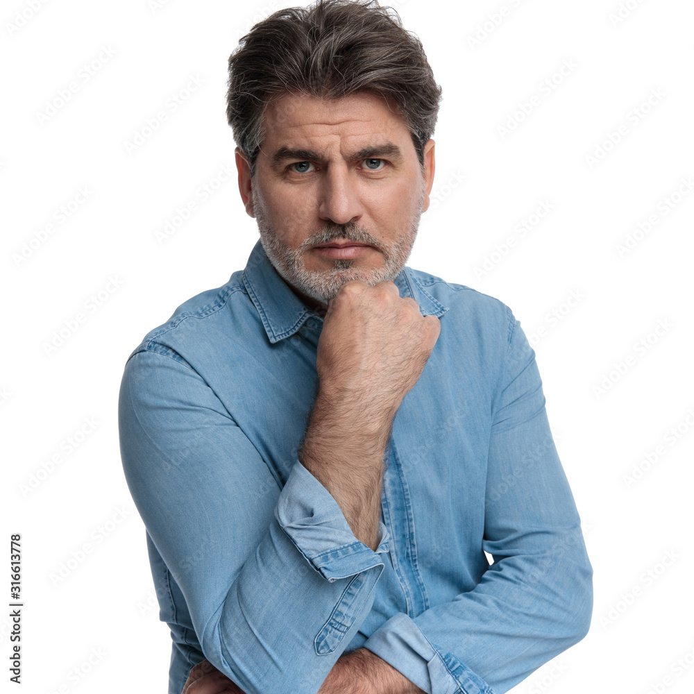 Angry casual man looking forward and frowning Angry casual man looking forward and frowning