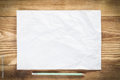 Obraz na płótnie Sheet of paper lying on wooden table w salonie