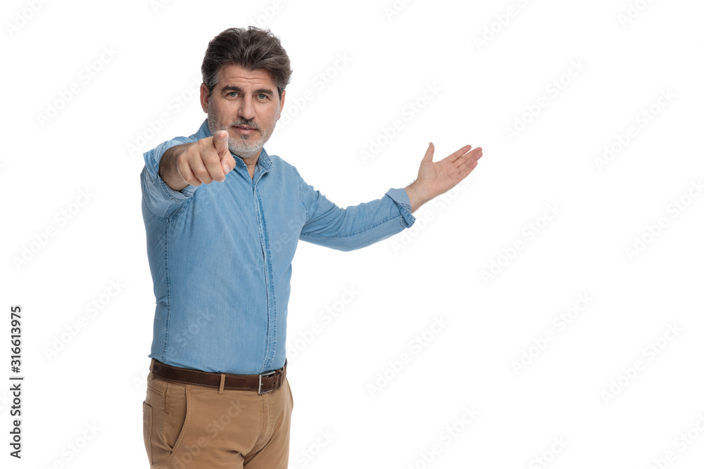 Motivated casual man presenting and pointing forward Motivated casual man presenting and pointing forward