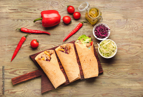 Composition with tasty doner kebab on wooden background