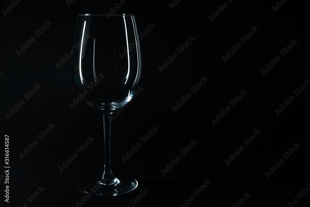 Glossy wine glass isolated on black with copy space Glossy wine glass isolated on black with copy space