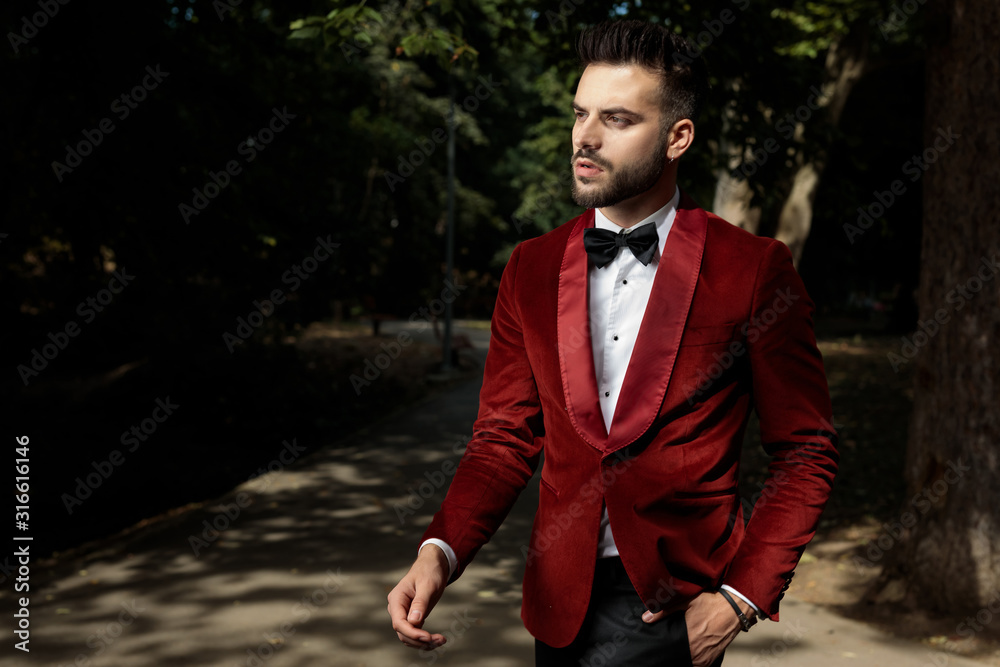 businessman standing with hand in pocket and looking away pensive businessman standing with hand in pocket and looking away pensive