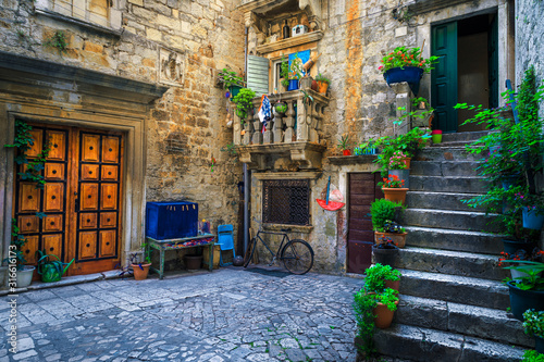 Fototapeta Naklejka Na Ścianę i Meble -  Rustic street view with stone houses in Trogir, Dalmatia, Croatia