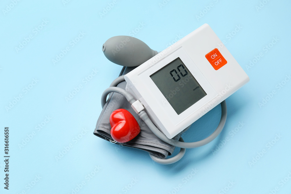 Electronic sphygmomanometer on color background Electronic sphygmomanometer on color background