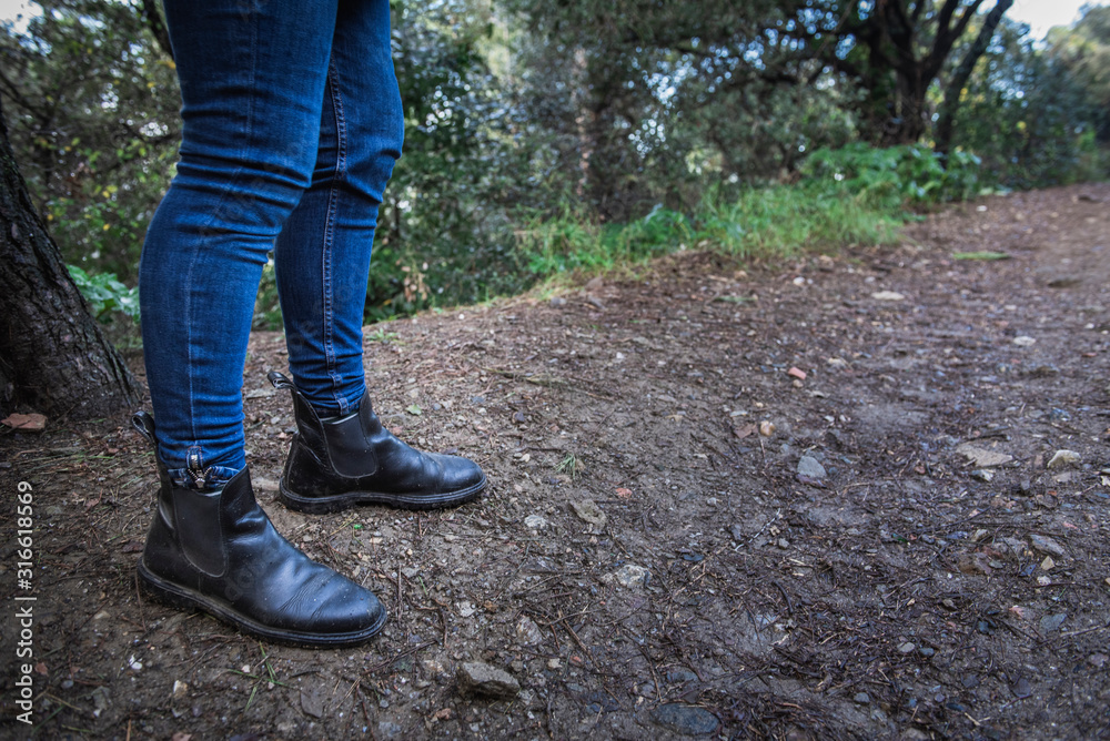 legs of a girl with boots on a forest legs of a girl with boots on a forest