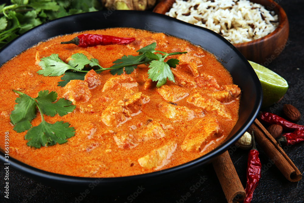 Chicken tikka masala spicy curry meat food in pot with rice and naan bread. indian food