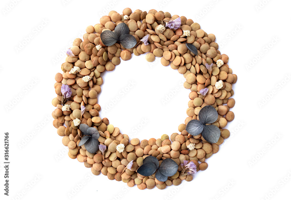 Circle made of food with flowers, round lentil pattern, note on a white background Circle made of food with flowers, round lentil pattern, note on a white background