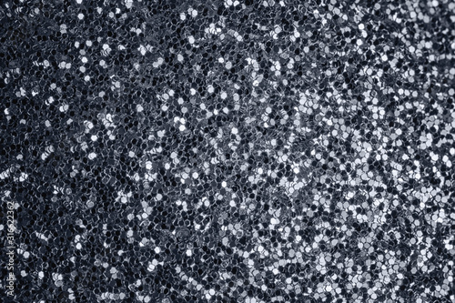 Gray shiny background from many small sparkles. Close-up, gray background for sites and layouts.