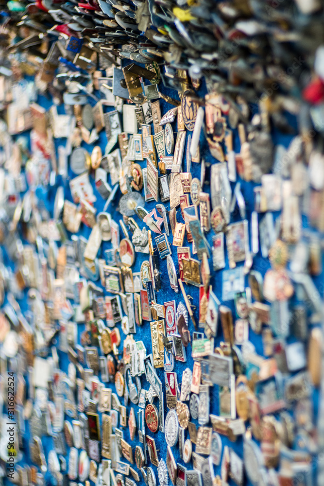 Fototapeta premium numerous badges with pebbles on the wall.
