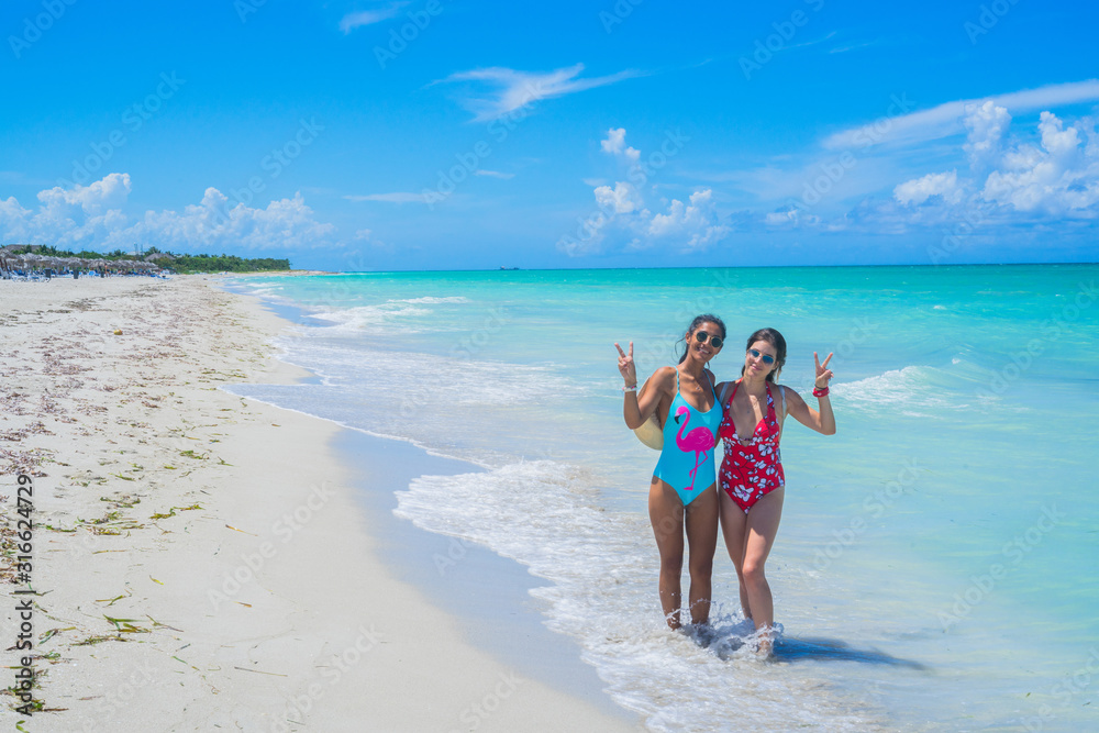 Two friends enjoying on the beach.