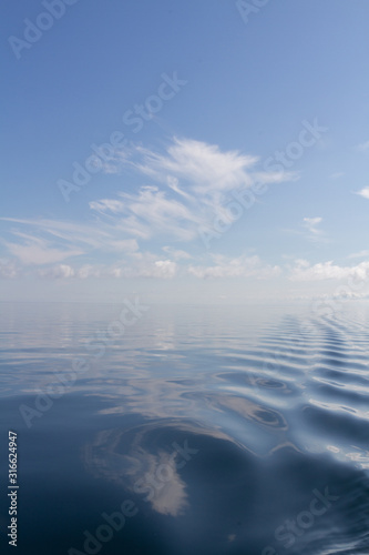 windless sea blue sky reflections © foto verwonder