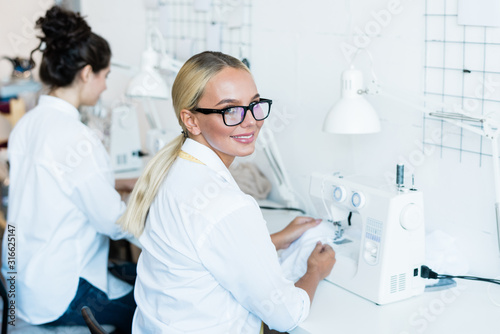 Blond woman at sewing machine