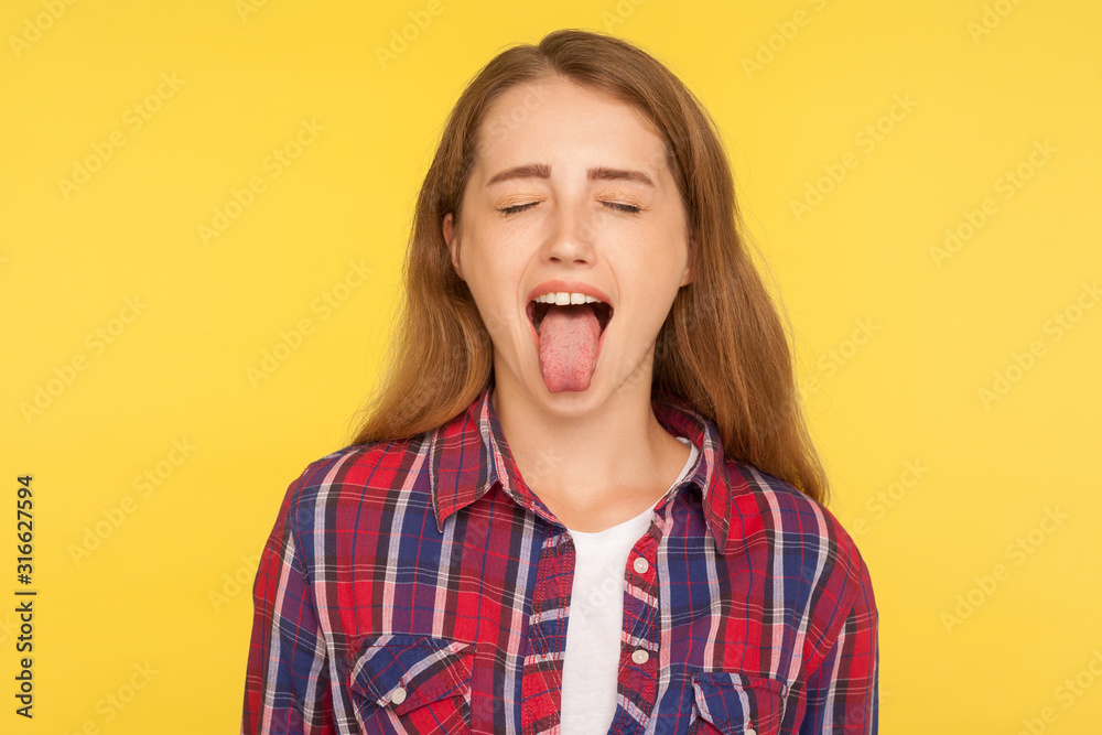 Portrait of naughty disobedient ginger girl in casual shirt standing with closed eyes and