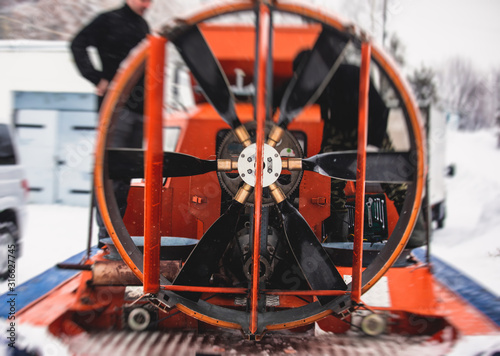 View of rescue team Hovercraft. hover craft transport boat crossing frozen river lake on the ice in the winter snowy day