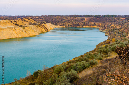 Lake with sandy bank in the abandoned coal quarry