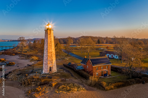 Lighthouse with Sun Reflecting in Light