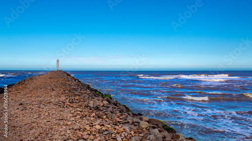 The Mampituba Lighthouse located in the city of Torres, in the state of Rio Grande do Sul photo