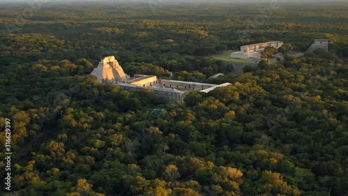 Wallpaper Mural Aerial, rising, drone shot, towards the Uxmal pyramid, Mayan city ruins, at sunset, in Yucatan, Mexico Torontodigital.ca