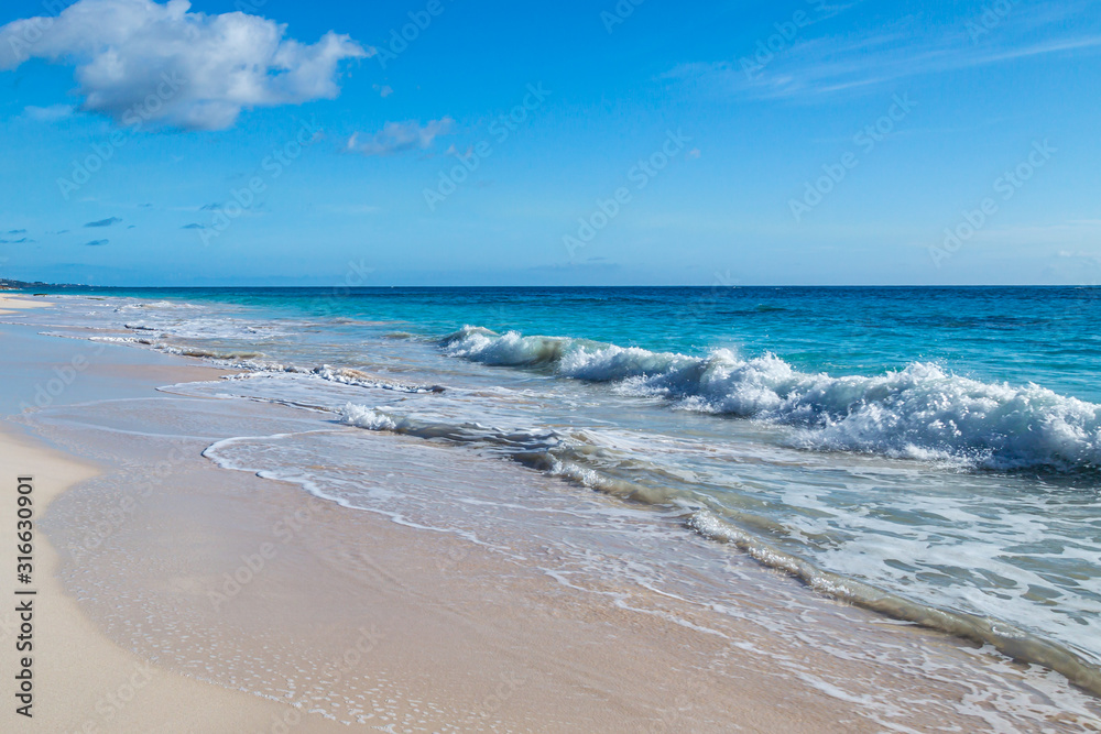 Waves lapping the sand, at Elbow Beach on the island of Bermuda