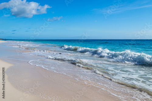 Waves lapping the sand  at Elbow Beach on the island of Bermuda