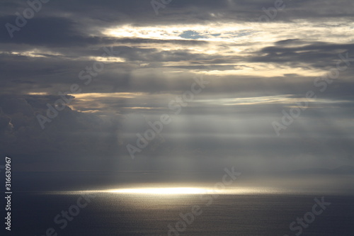sunrise with sun rays between the clouds