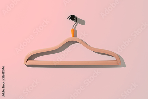 a simple empty clothes hanger on the wall hook, fashion cloth textile storage photo