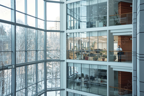 Interior of contemporary multi-floor business center with large windows