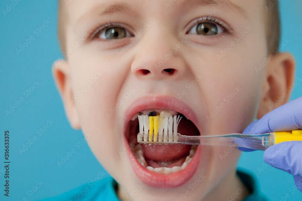 Little cute boy brushing his teeth on blue background Little cute boy brushing his teeth on blue background