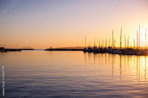 Sunset. Sunset at the port of Estepona. © Ekaterina