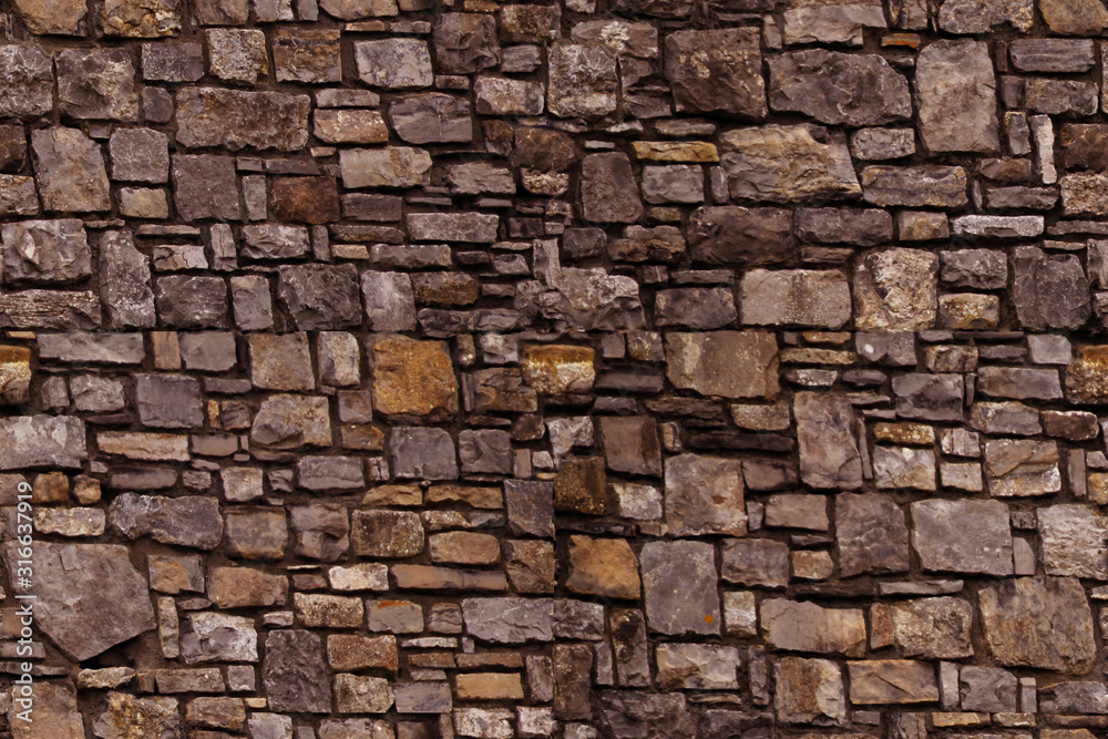 seamless texture of the old stone wall for the designer, brown gray background