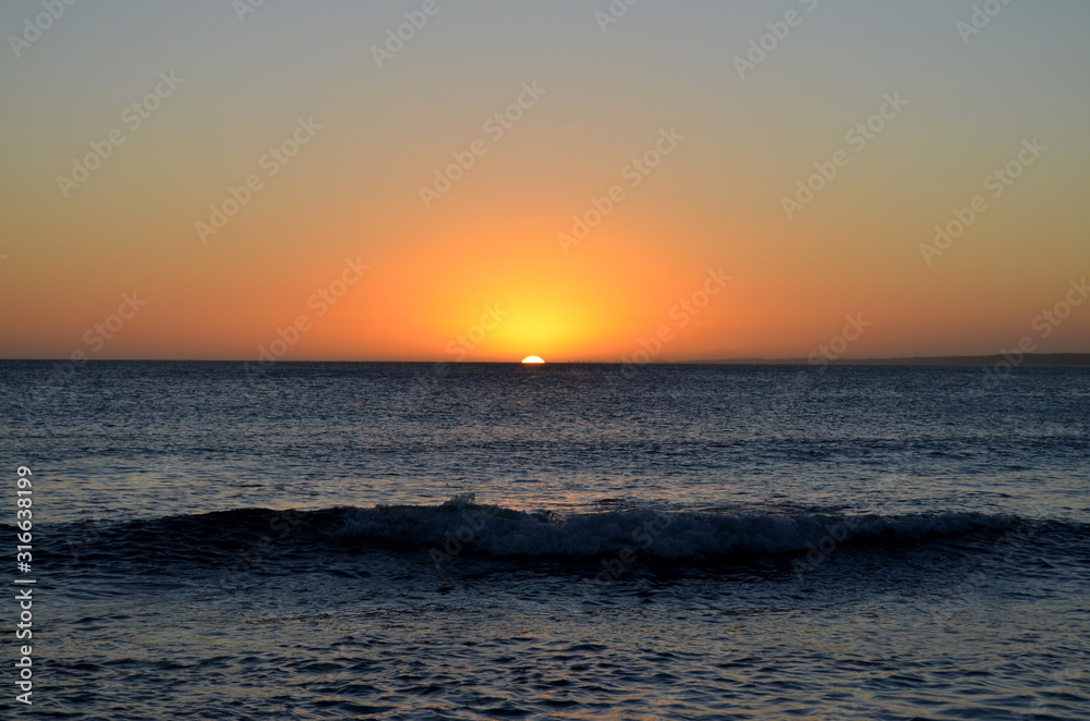 Wave breaking in the coast with a beautiful sunset at the back. Beach Sunsets Wave breaking in the coast with a beautiful sunset at the back. Beach Sunsets