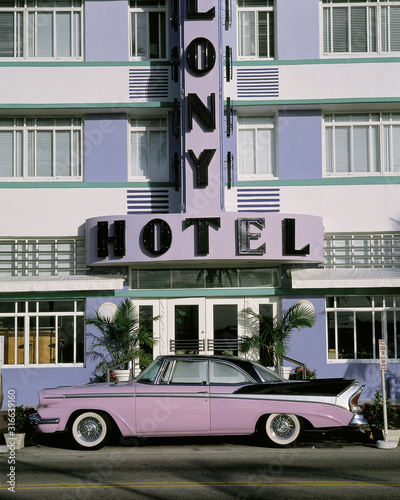 This is the Colony Hotel on the strip of South Beach Miami. There is a purple and black vintage car parked in front of the hotel. © spiritofamerica