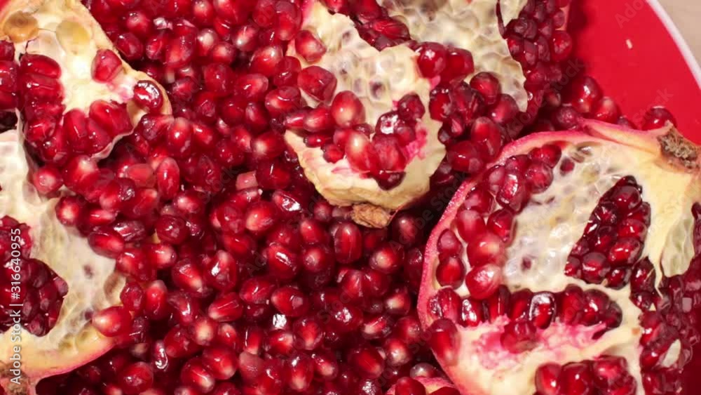 Rotating pomegranate seeds close up 