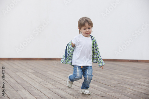 Happy boy runs around the stage. Blurred image