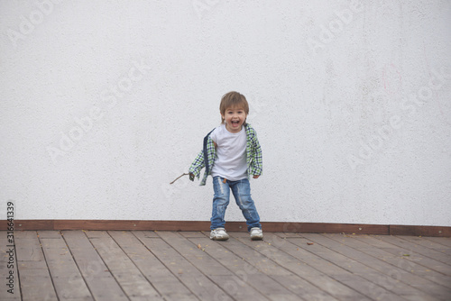 Happy boy runs around the stage. Blurred image