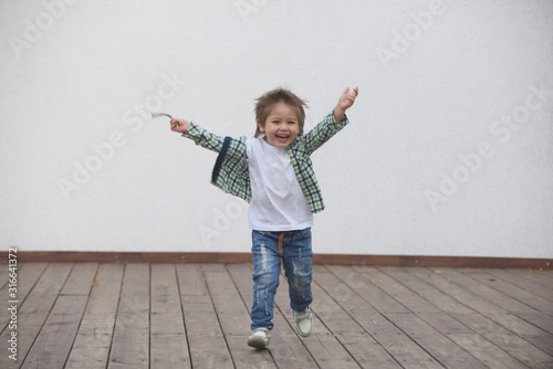 Happy boy runs around the stage. Blurred image