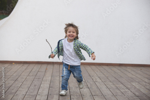 Happy boy runs around the stage. Blurred image